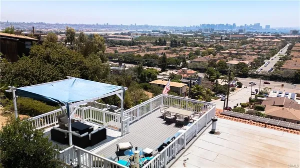 a view of a balcony with chairs and wooden floor