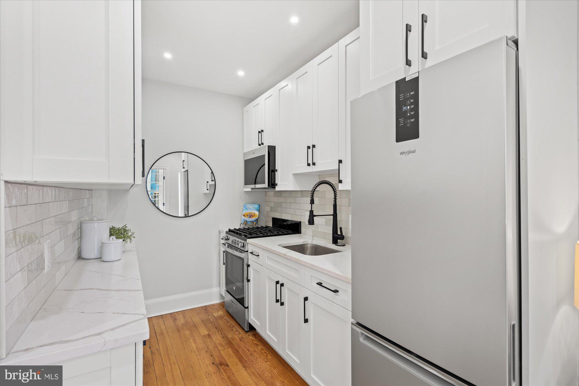524 Queen Street Alexandria, VA 22314 - Photo 11 of 64 a kitchen with stainless steel appliances a white cabinet and a granite top