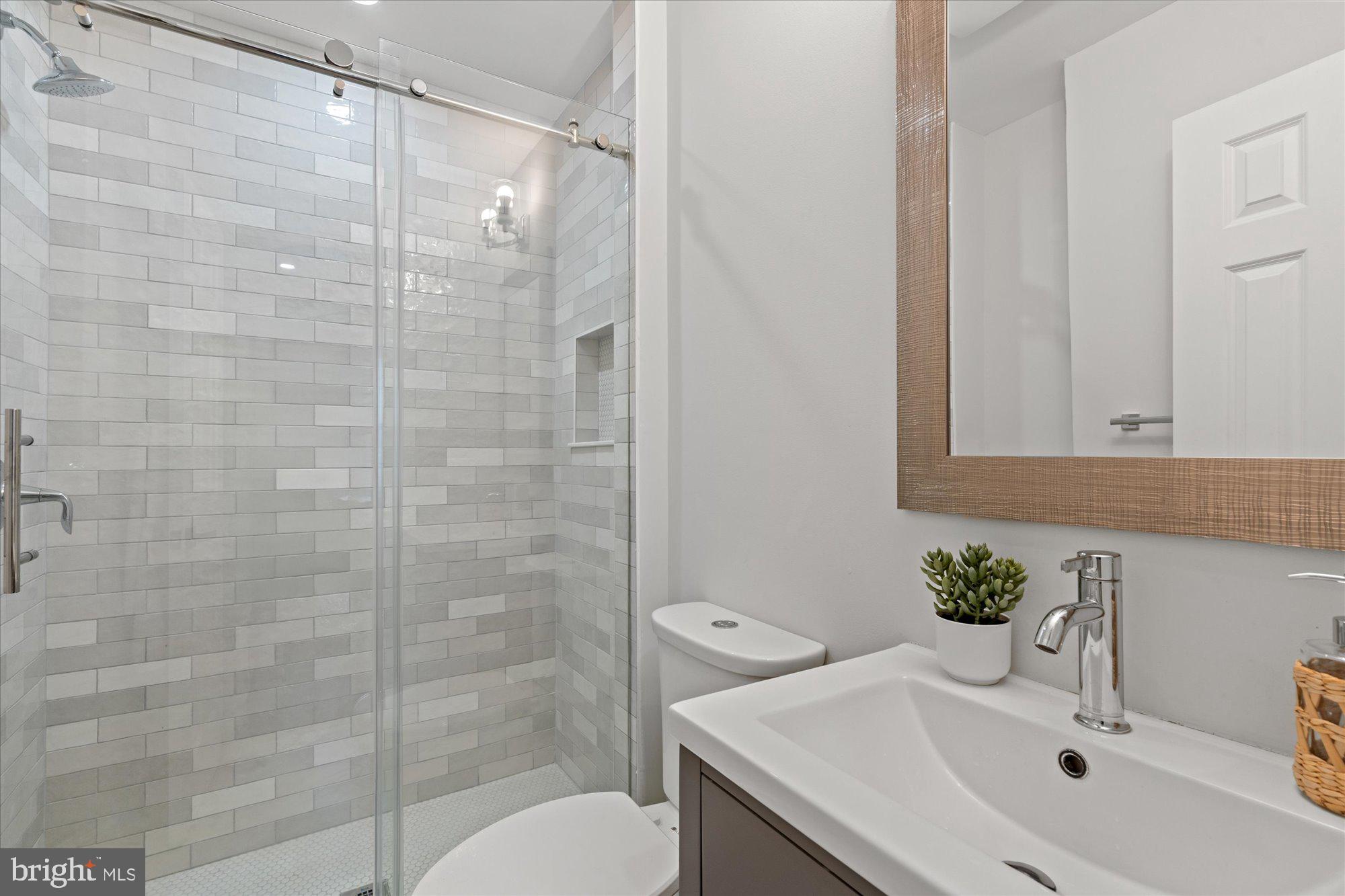 524 Queen Street Alexandria, VA 22314 - Photo 15 of 64 a bathroom with a sink a toilet and shower