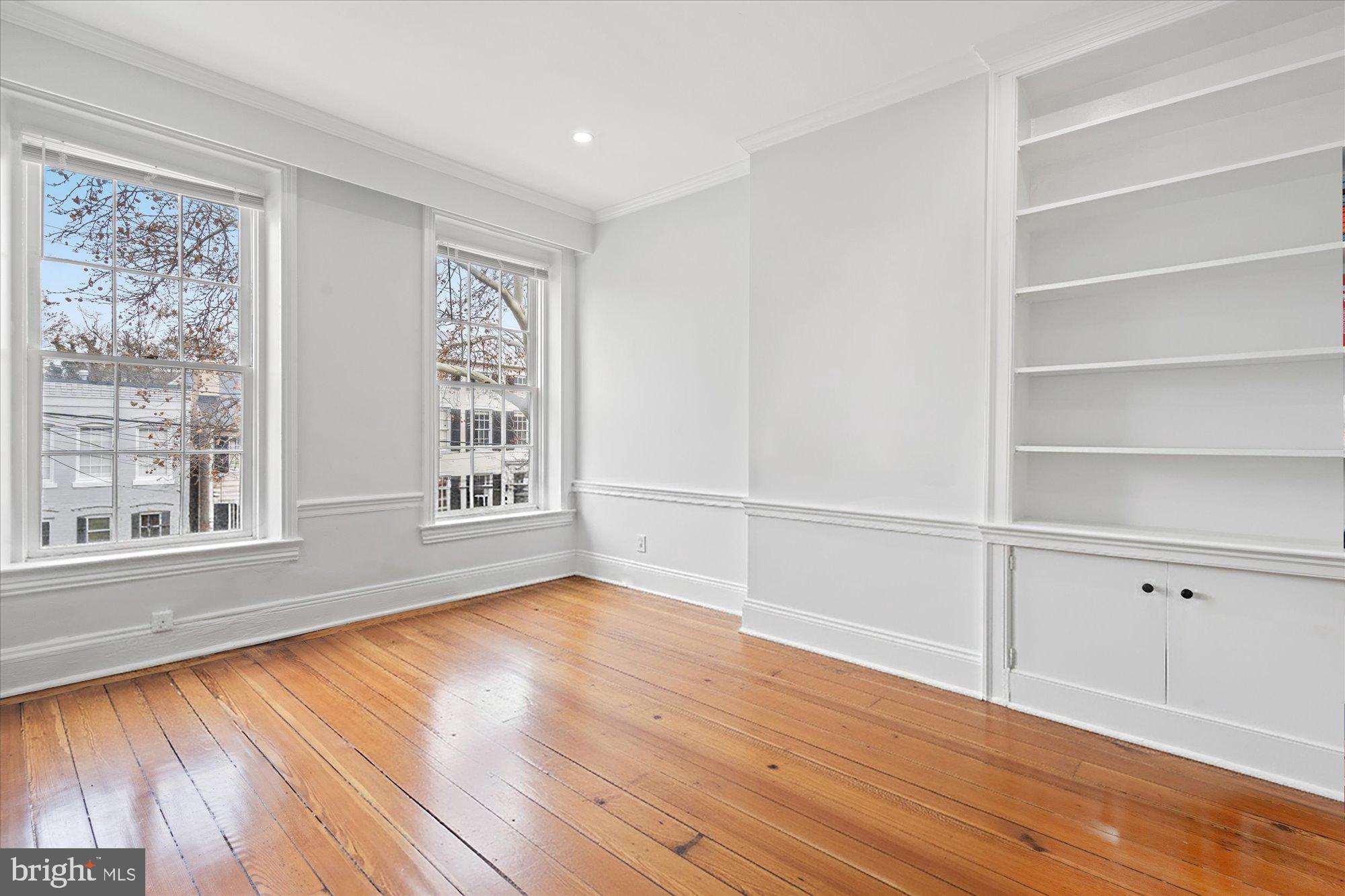 524 Queen Street Alexandria, VA 22314 - Photo 16 of 64 a view of an empty room with wooden floor and a window