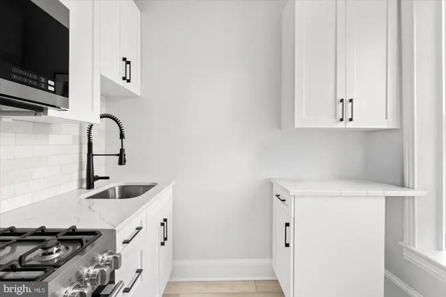 a view of a room with wooden floor and cabinet