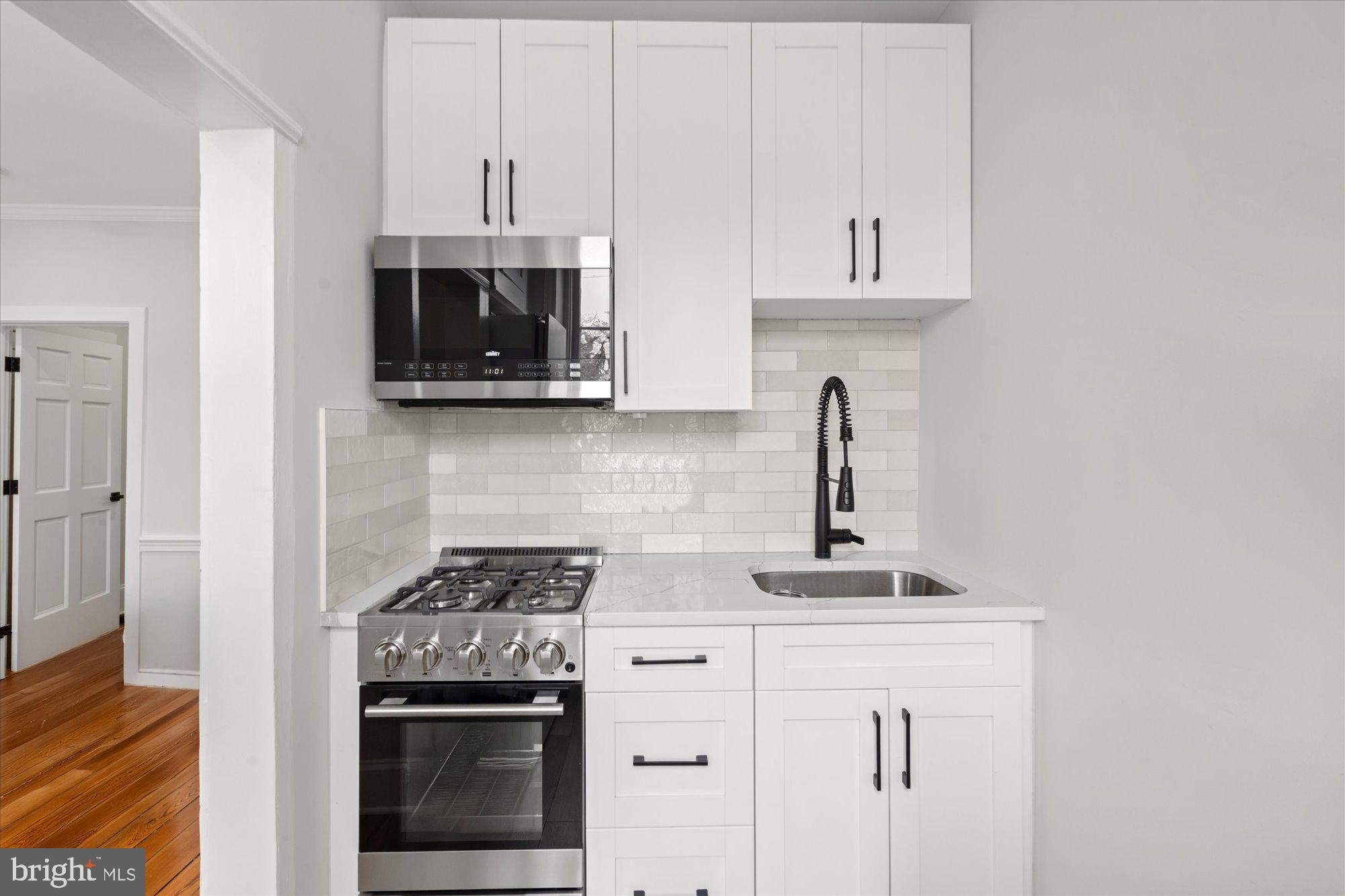 524 Queen Street Alexandria, VA 22314 - Photo 19 of 64 a kitchen with stainless steel appliances granite countertop a stove and a microwave