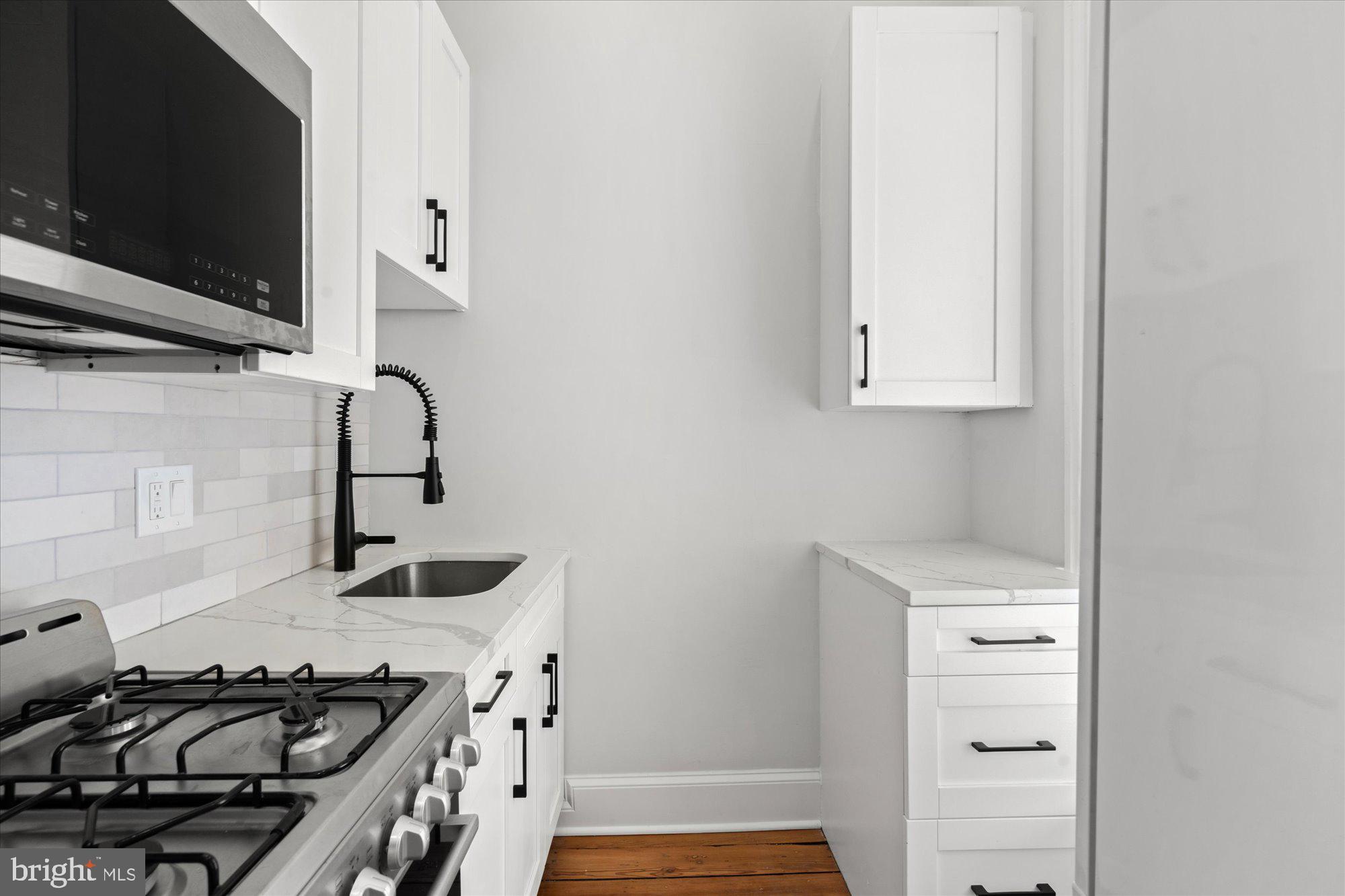 524 Queen Street Alexandria, VA 22314 - Photo 27 of 64 a kitchen with a sink and a stove top oven