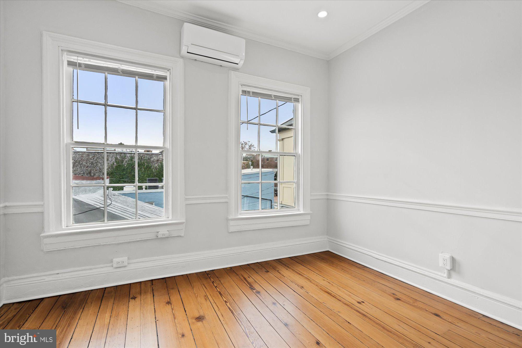 524 Queen Street Alexandria, VA 22314 - Photo 30 of 64 a view of an empty room with wooden floor and a window
