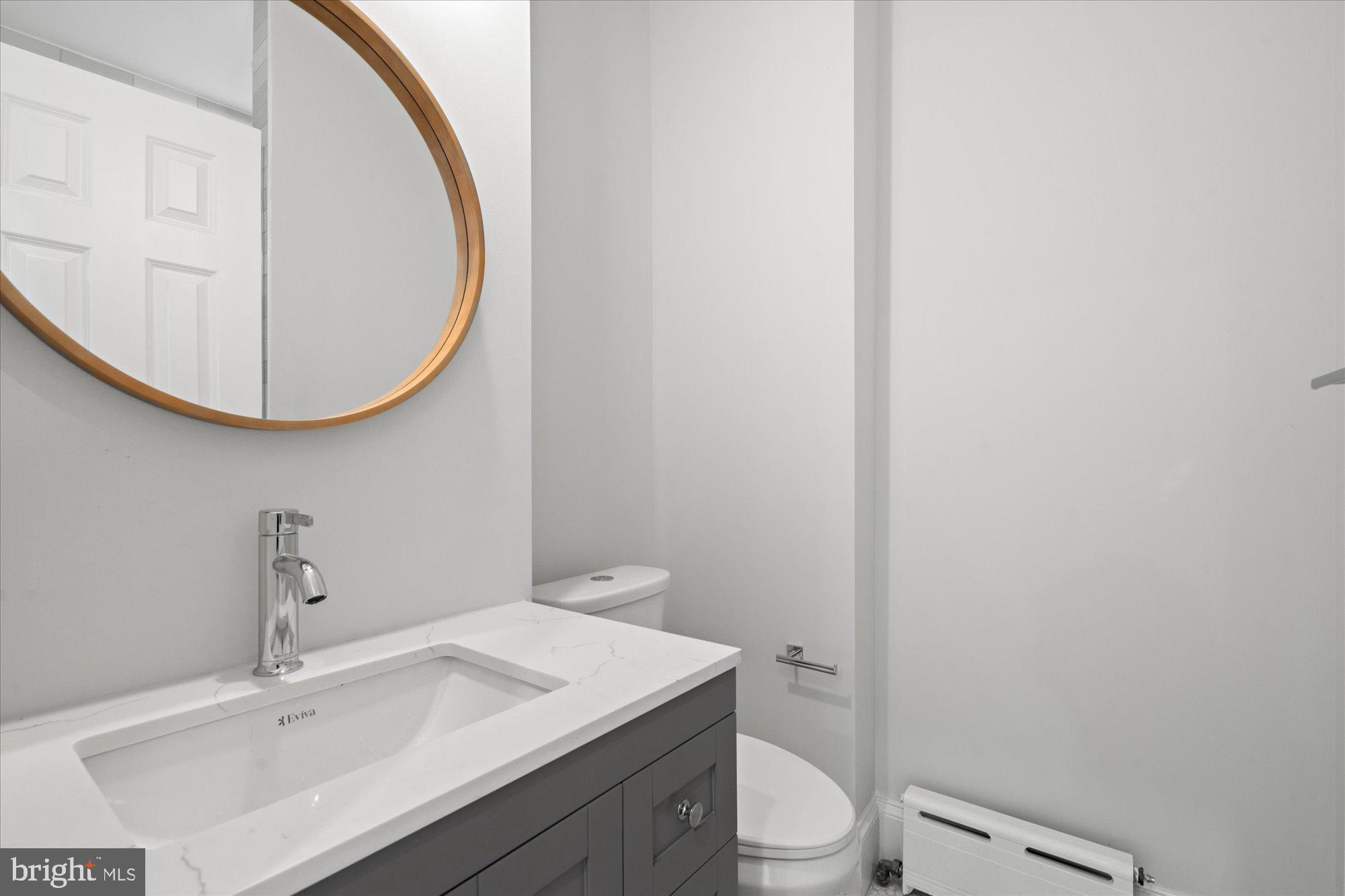 524 Queen Street Alexandria, VA 22314 - Photo 33 of 64 a bathroom with a toilet a sink and mirror