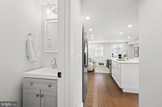 a bathroom with a toilet a sink and a mirror