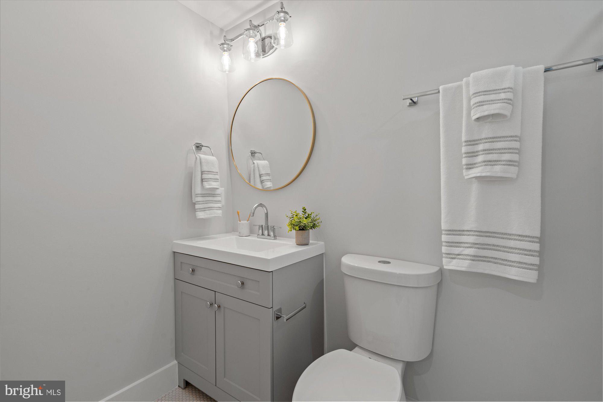 524 Queen Street Alexandria, VA 22314 - Photo 49 of 64 a bathroom with a toilet a sink and a mirror