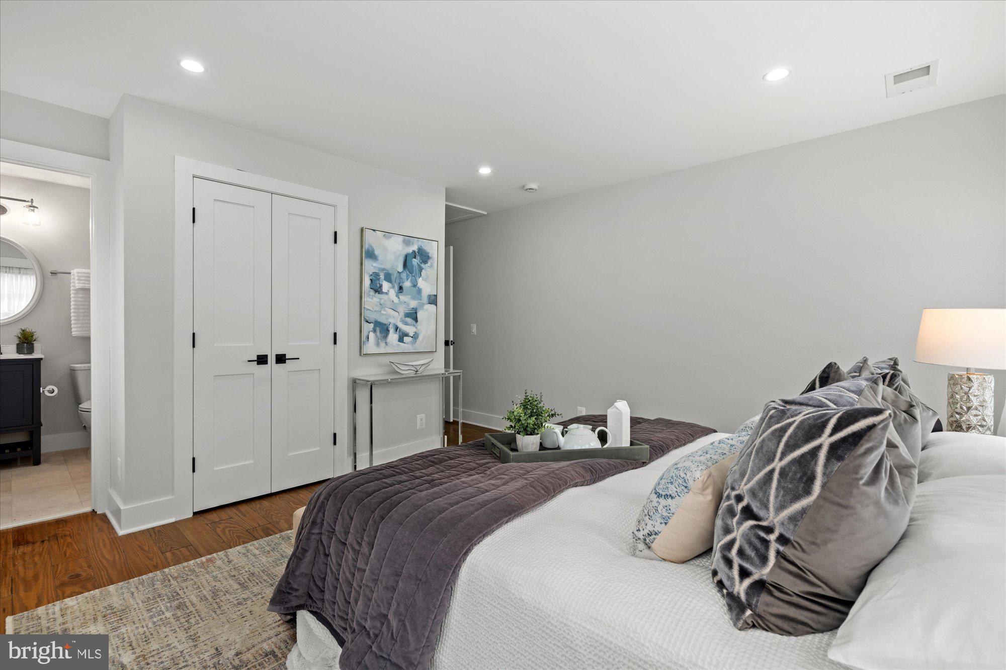 524 Queen Street Alexandria, VA 22314 - Photo 53 of 64 a bedroom with a bed and wooden floor