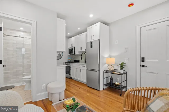 a kitchen with white cabinets a sink and dishwasher