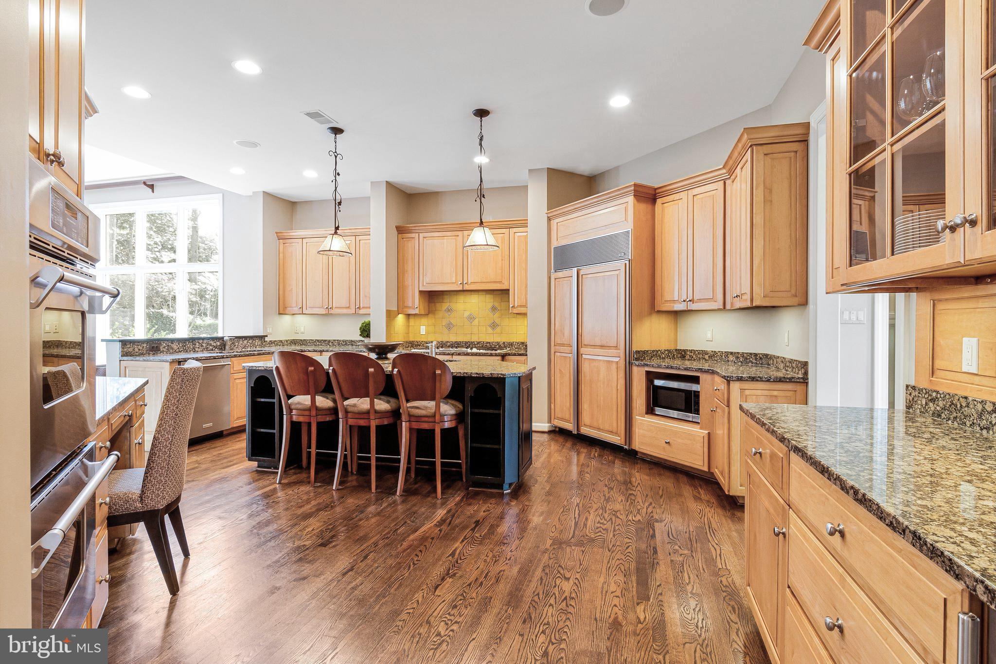 1029 Founders Ridge Lane McLean, VA 22102 - Photo 22 of 71 a large kitchen with lots of counter space a sink appliances and a dining table