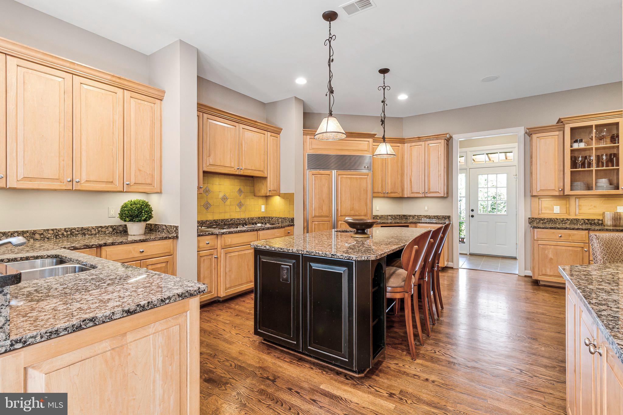 1029 Founders Ridge Lane McLean, VA 22102 - Photo 23 of 71 a kitchen with stainless steel appliances granite countertop wooden floor sink and stove