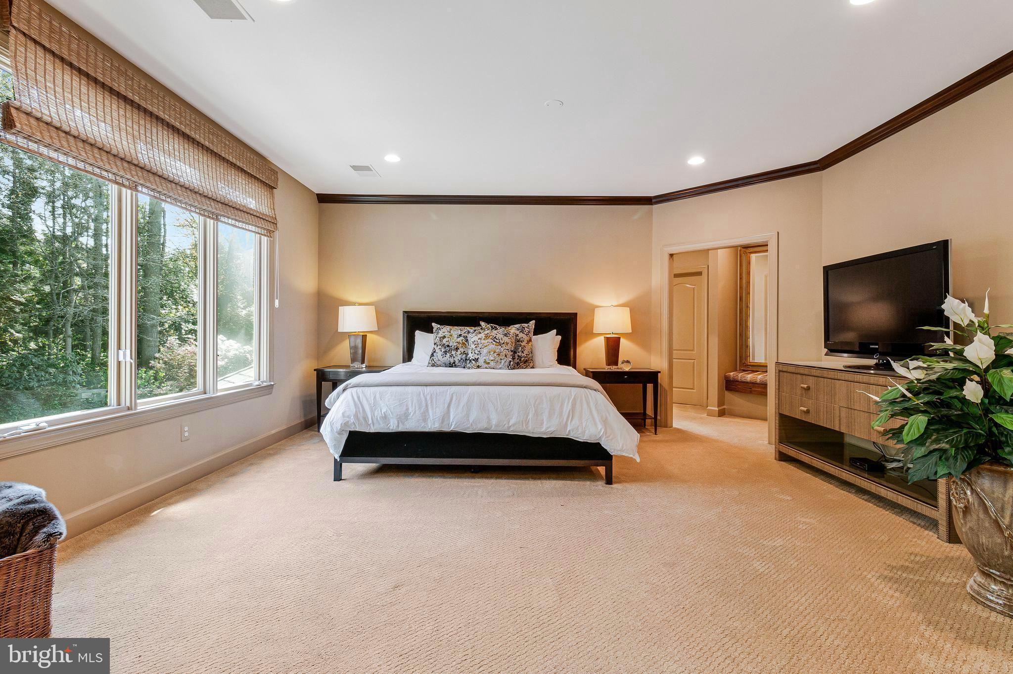1029 Founders Ridge Lane McLean, VA 22102 - Photo 31 of 71 a spacious bedroom with a bed and a flat screen television