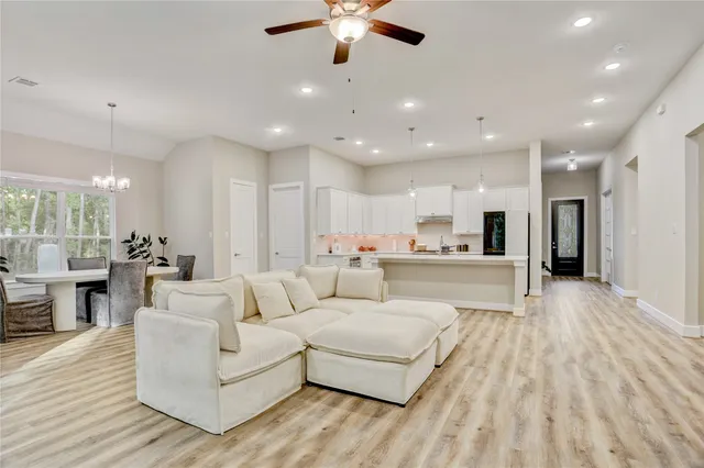 a living room with furniture and a wooden floor