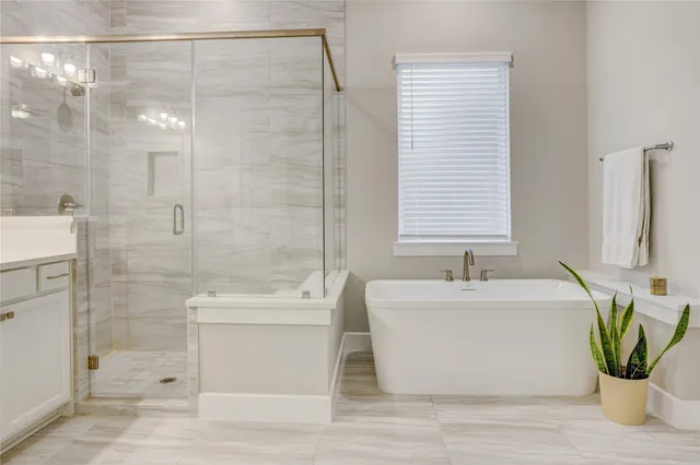 a bathroom with a sink a bathtub and a shower