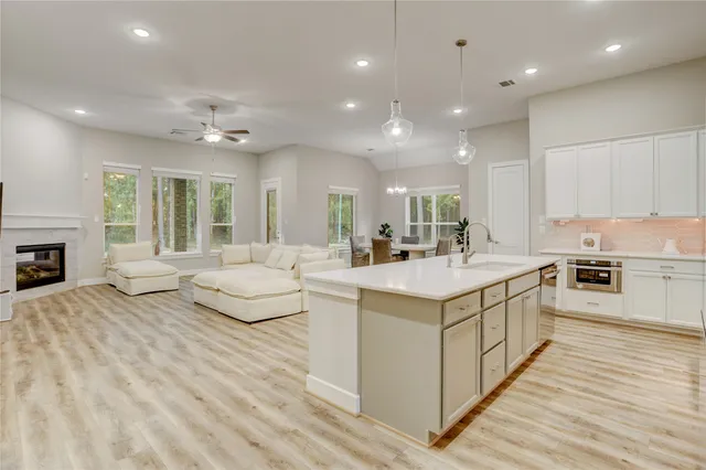 a kitchen with kitchen island granite countertop a stove and a sink