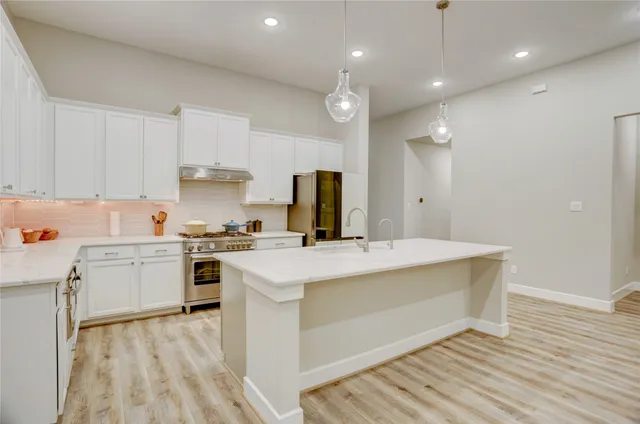 a kitchen with a stove a sink and a refrigerator