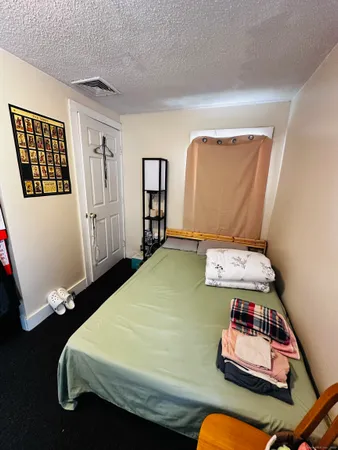 a bedroom with a bed and cabinets