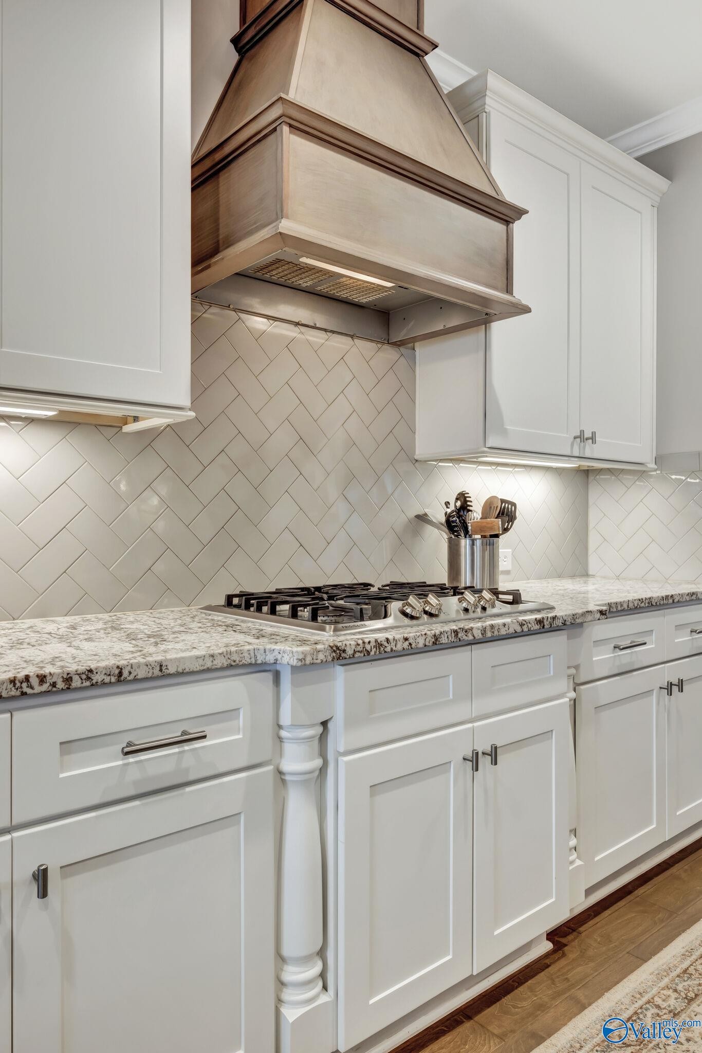 218 Southwest Winterbranch Road Madison, AL 35756 - Photo 13 of 47 a kitchen with granite countertop white cabinets and white appliances