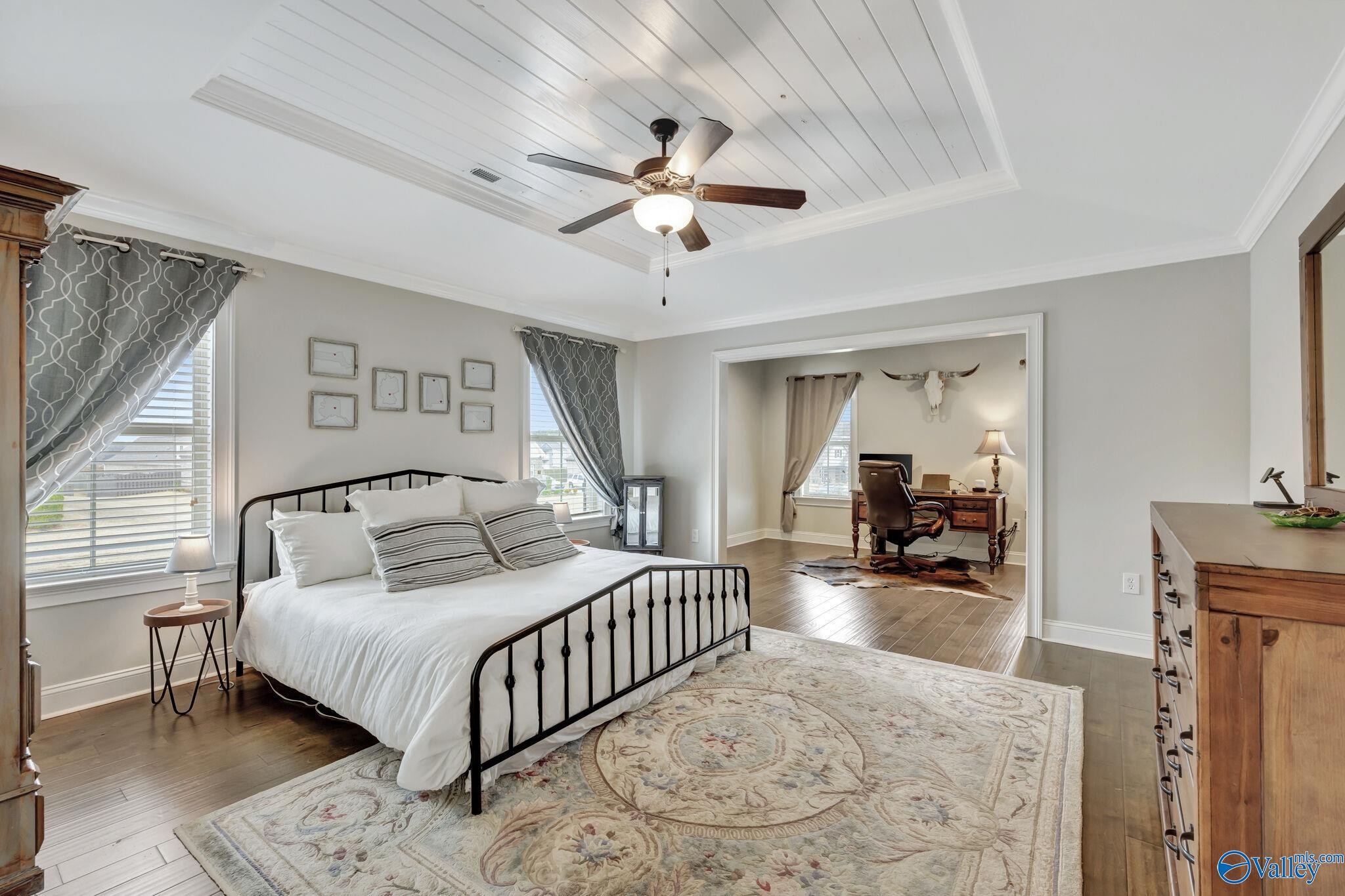 218 Southwest Winterbranch Road Madison, AL 35756 - Photo 16 of 47 a bedroom with a large bed and a chandelier