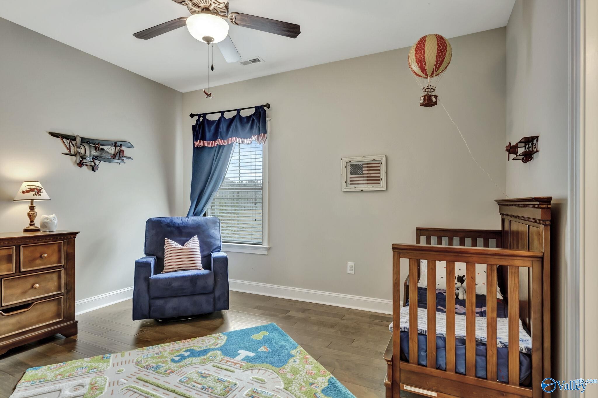 218 Southwest Winterbranch Road Madison, AL 35756 - Photo 33 of 47 a bedroom with furniture and wooden floor