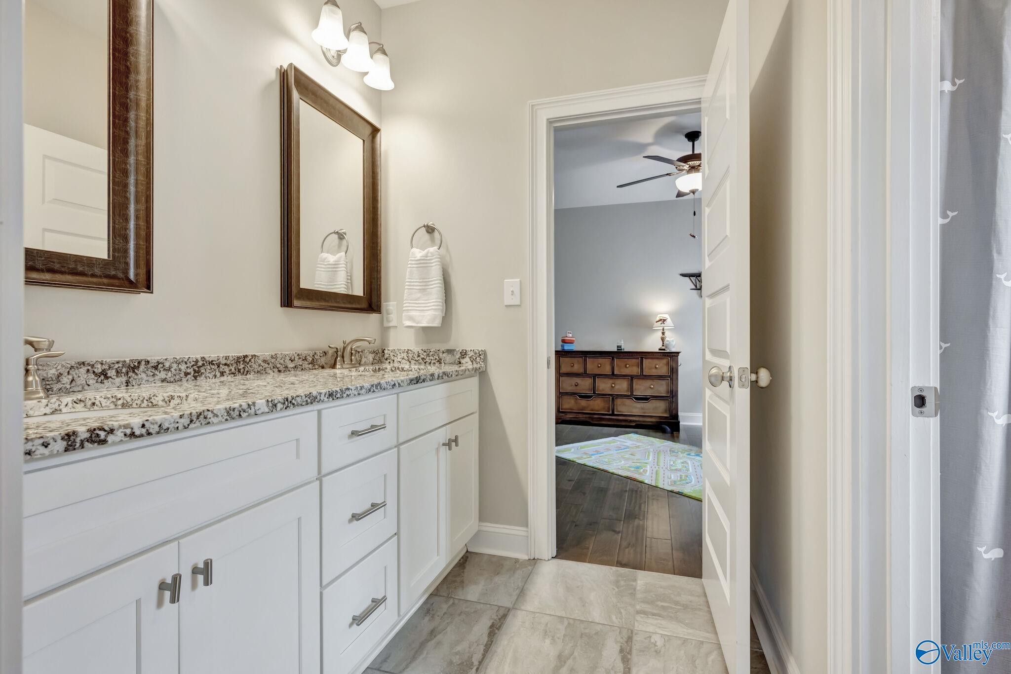 218 Southwest Winterbranch Road Madison, AL 35756 - Photo 35 of 47 a en suite bathroom with a granite countertop sink and a mirror