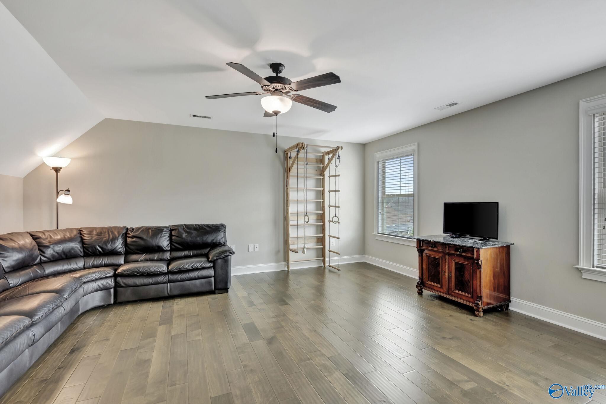 218 Southwest Winterbranch Road Madison, AL 35756 - Photo 39 of 47 a living room with furniture and a flat screen tv