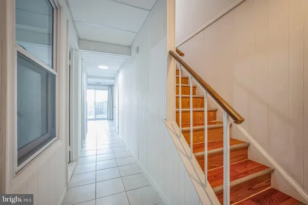 a view of entryway with wooden floor and stairs