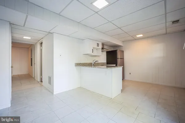 a view of a kitchen with a sink and cabinets