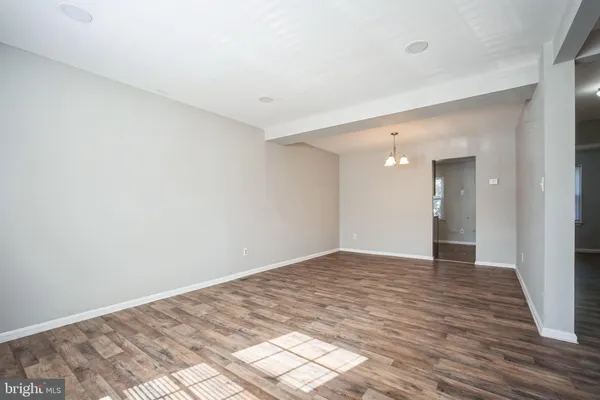 a view of an empty room and wooden floor