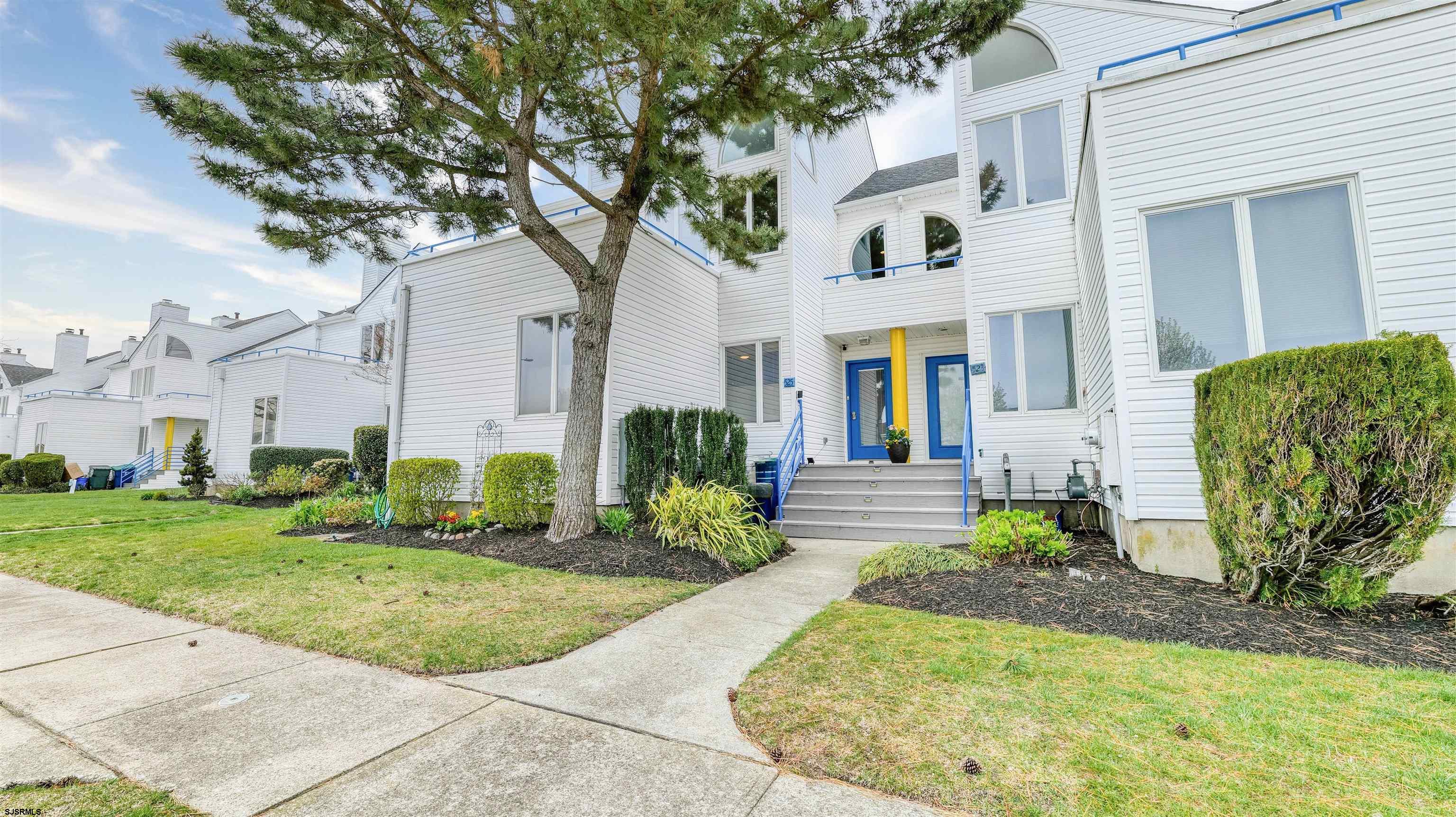 525 Lagoon Boulevard Brigantine, NJ 08203 - Photo 11 of 52 a front view of a house with garden and plants