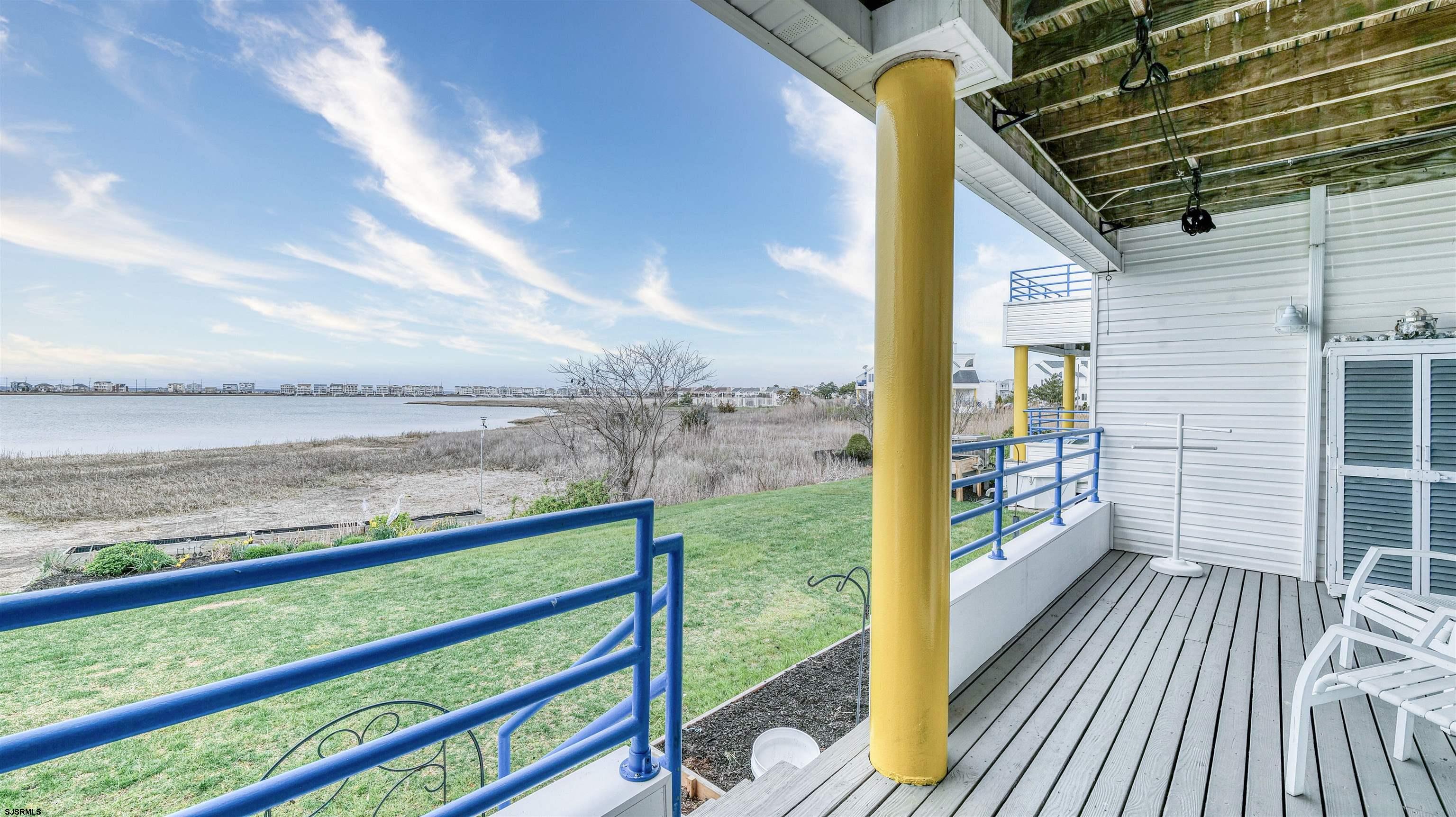 525 Lagoon Boulevard Brigantine, NJ 08203 - Photo 18 of 52 a view of a balcony with floor to ceiling windows wooden floor
