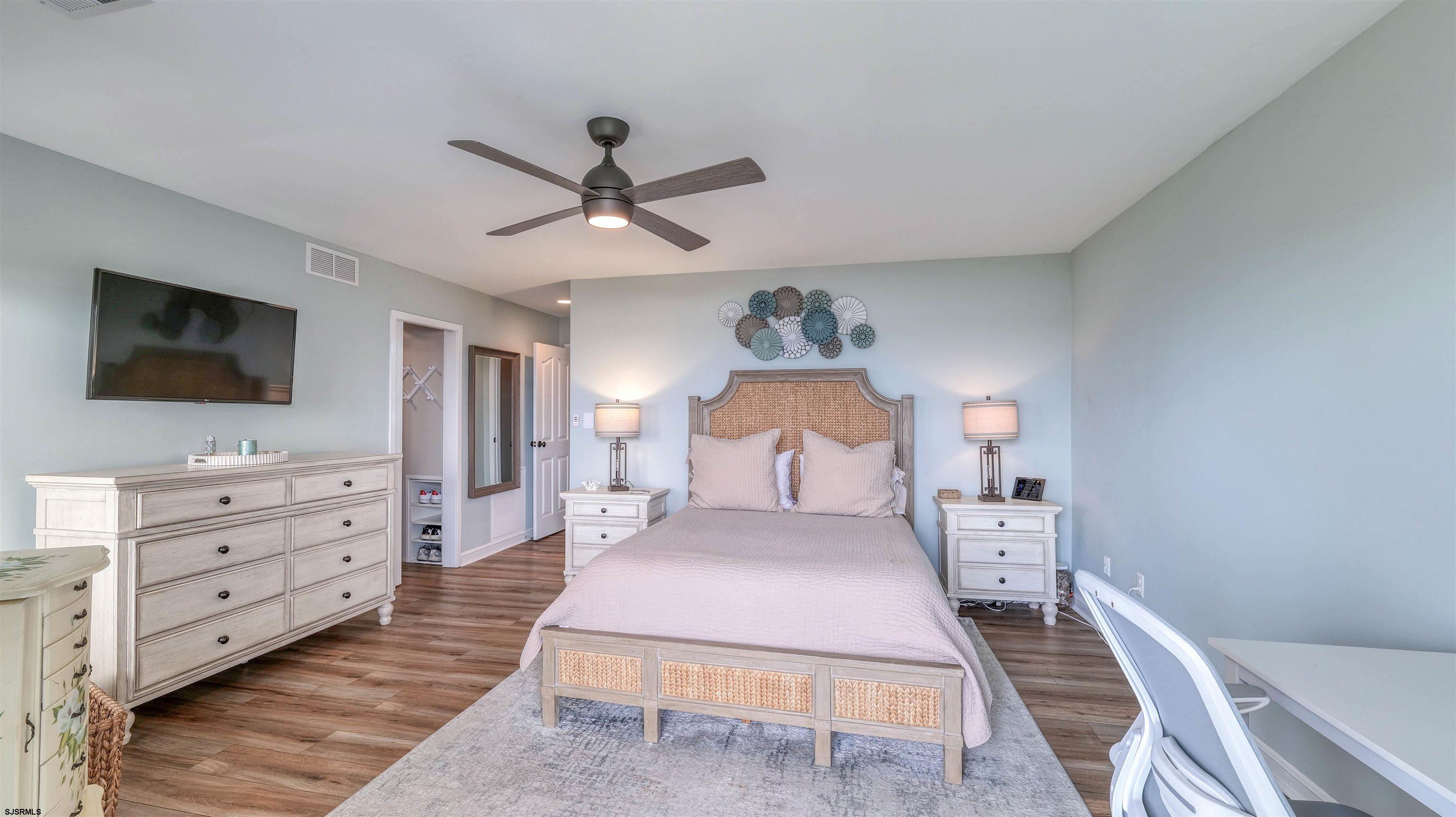 525 Lagoon Boulevard Brigantine, NJ 08203 - Photo 21 of 52 a bedroom with a large bed and a flat screen tv