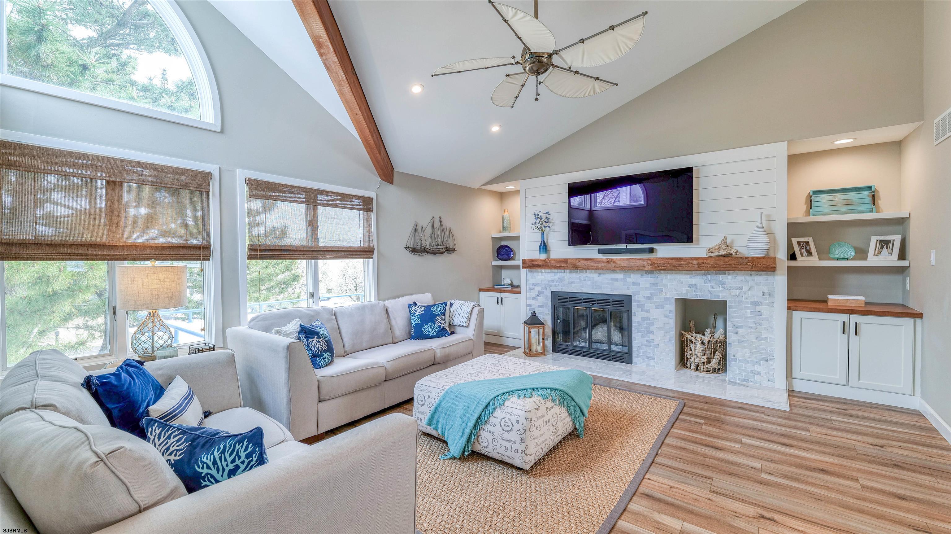525 Lagoon Boulevard Brigantine, NJ 08203 - Photo 29 of 52 a living room with fireplace furniture and a flat screen tv