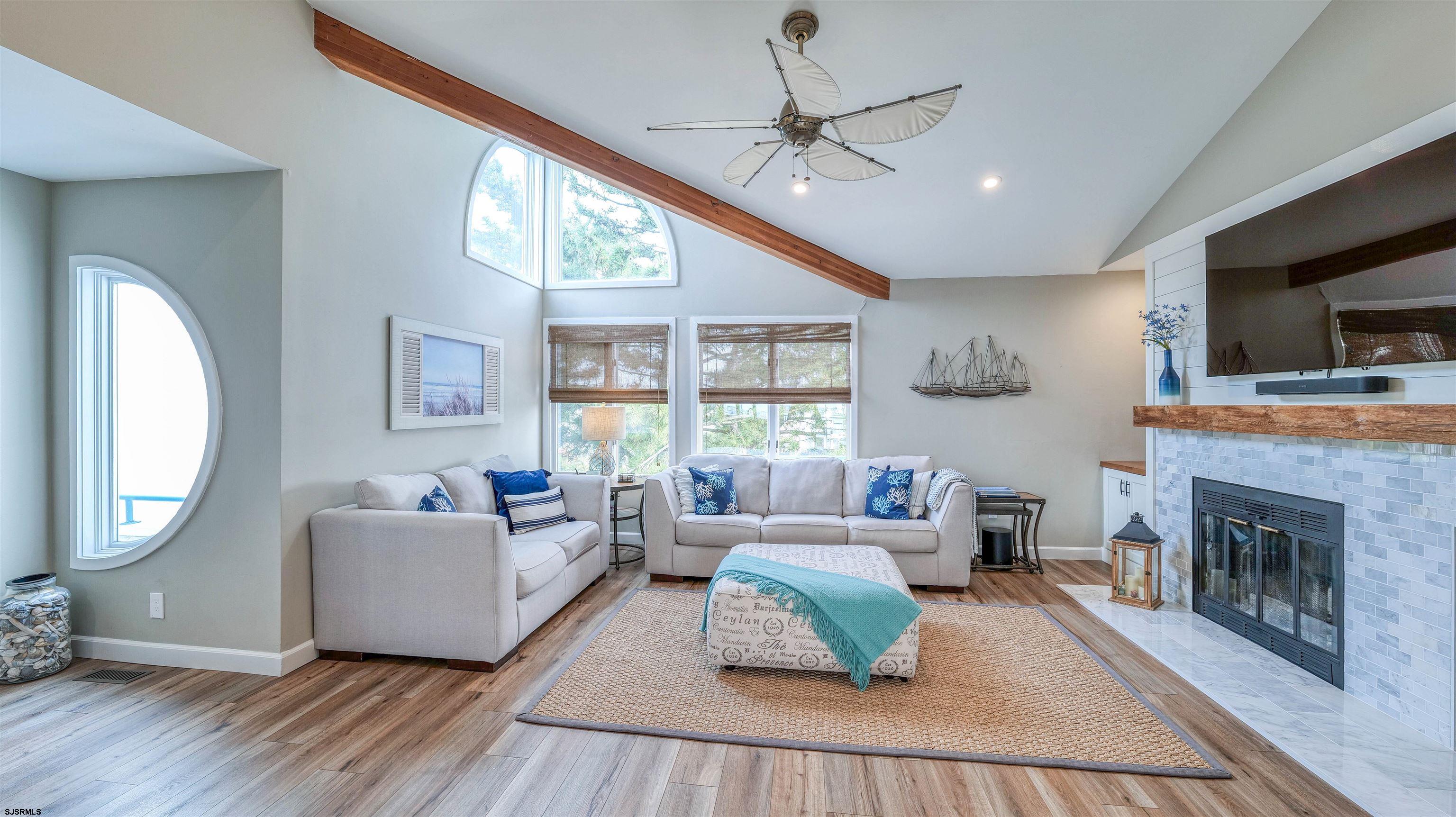 525 Lagoon Boulevard Brigantine, NJ 08203 - Photo 30 of 52 a living room with furniture and a fireplace