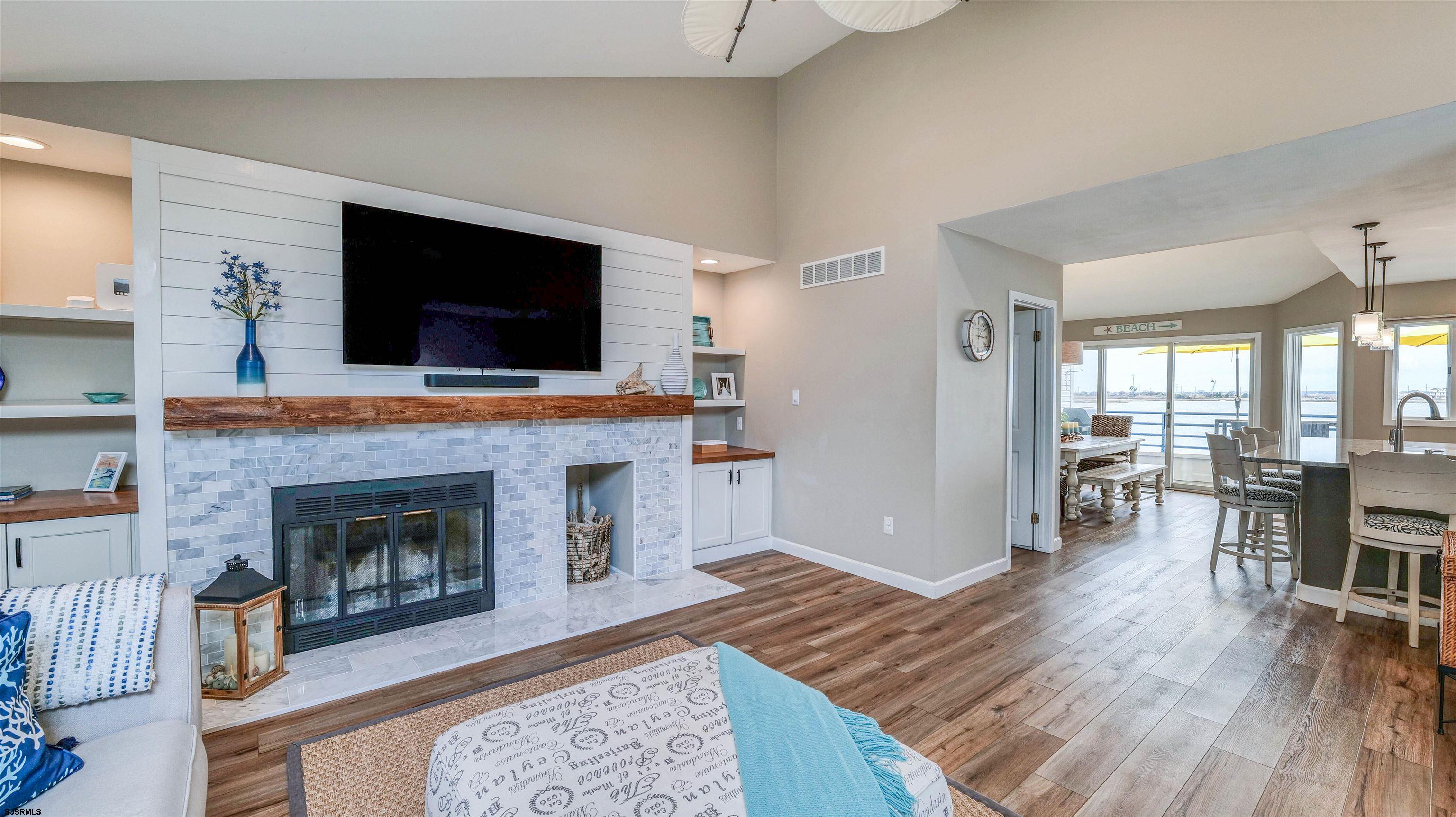 525 Lagoon Boulevard Brigantine, NJ 08203 - Photo 32 of 52 a living room with furniture fireplace and flat screen tv