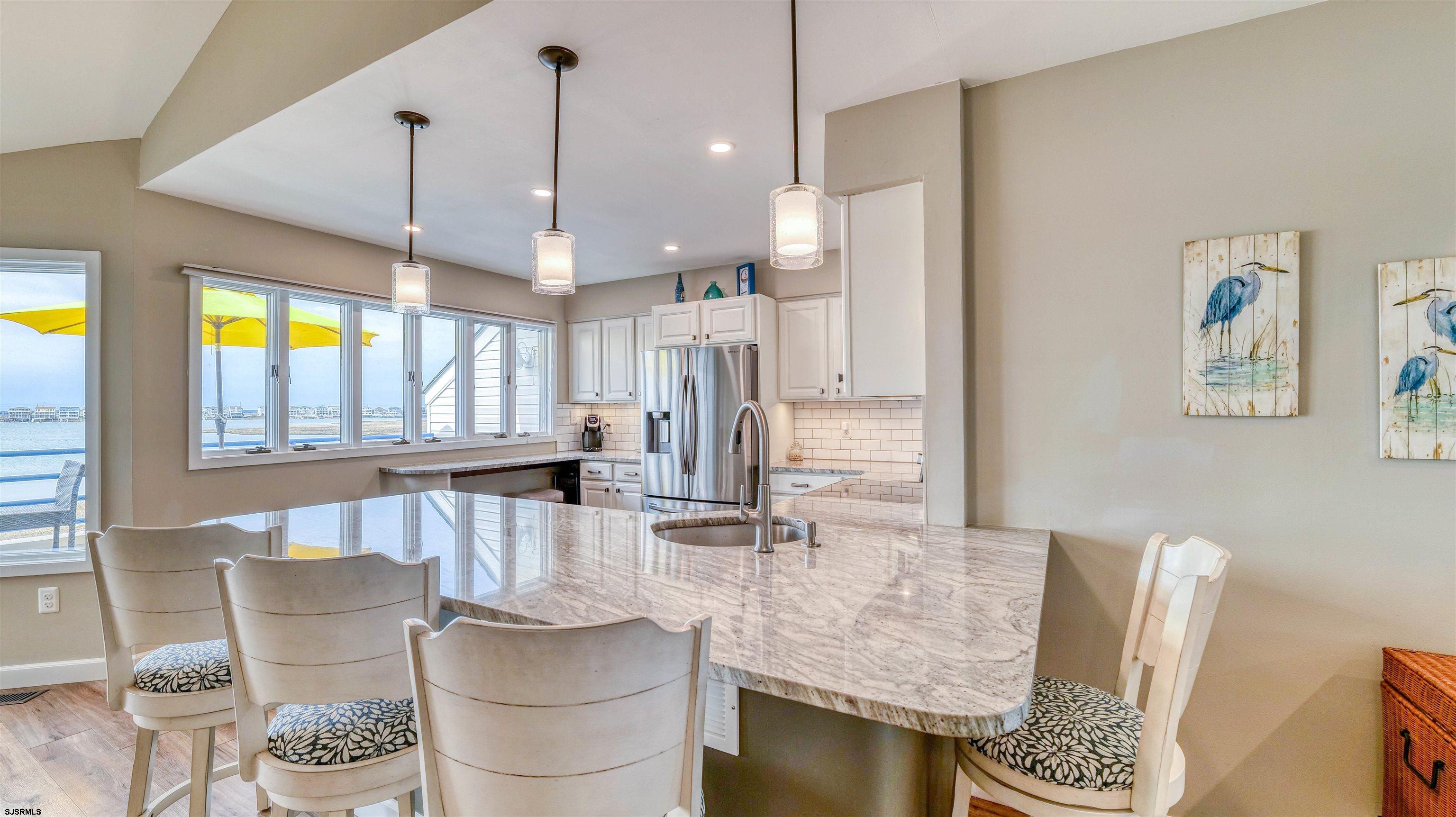 525 Lagoon Boulevard Brigantine, NJ 08203 - Photo 40 of 52 a living room with furniture and a large window