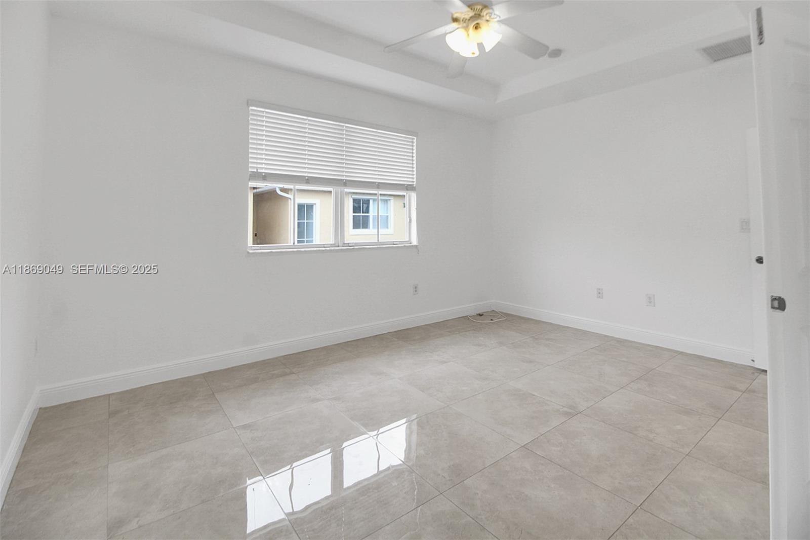 11724 Southwest 137th Path Miami, FL 33186 - Photo 17 of 33 an empty room with a chandelier fan