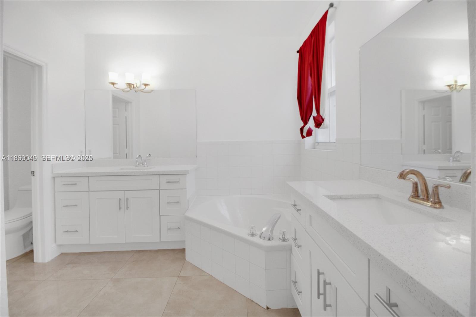 11724 Southwest 137th Path Miami, FL 33186 - Photo 18 of 33 a bathroom with a sink vanity and a mirror