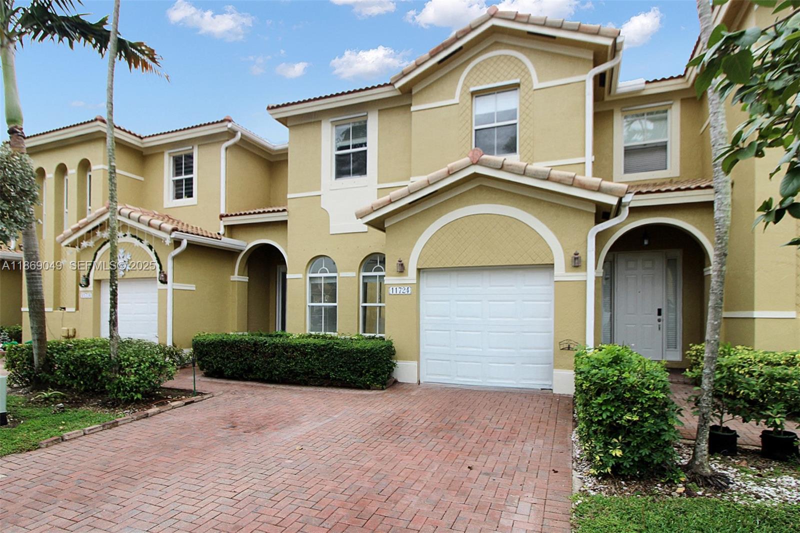 11724 Southwest 137th Path Miami, FL 33186 - Photo 2 of 33 a front view of a house with a garden