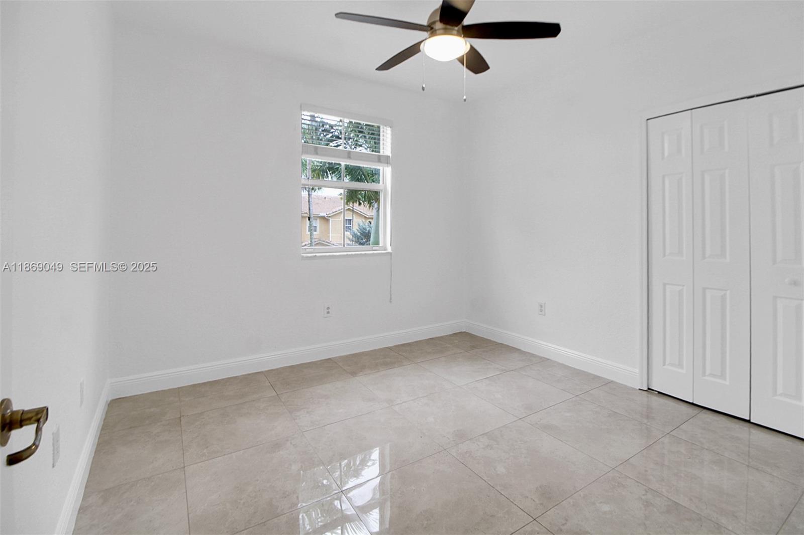 11724 Southwest 137th Path Miami, FL 33186 - Photo 25 of 33 an empty room with windows and fan