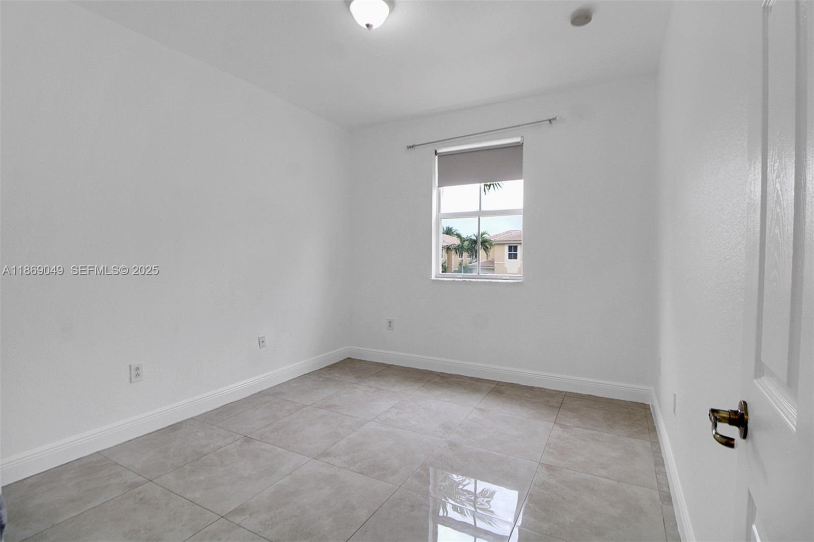 11724 Southwest 137th Path Miami, FL 33186 - Photo 27 of 33 an empty room with a window