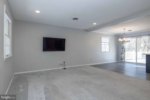 a kitchen with kitchen island granite countertop a sink cabinets and stainless steel appliances