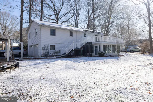a view of a yard covered with snow in front of house