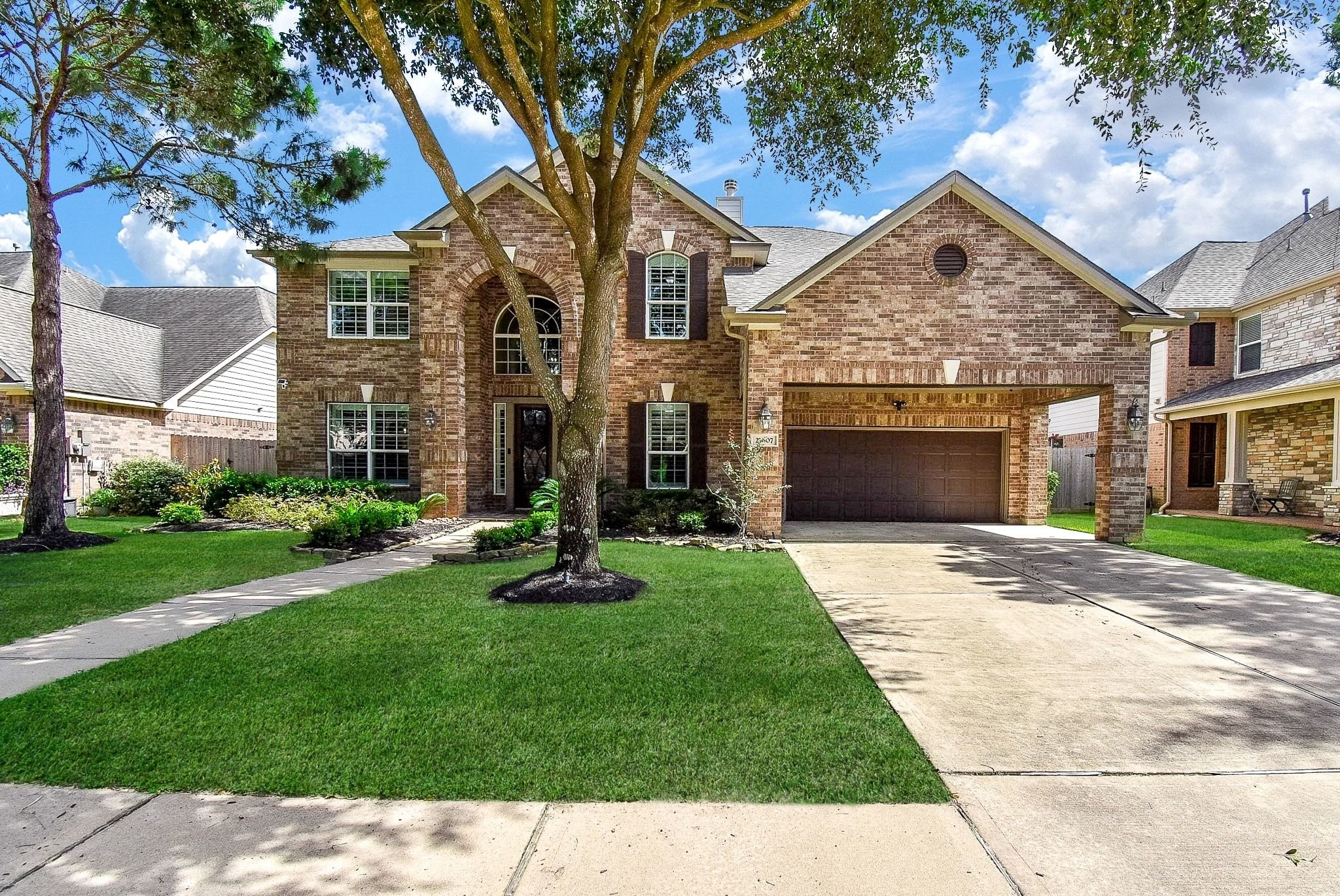 27607 Macklind Ridge Lane Katy, TX 77494 - Photo 6 of 50 Beautiful brick elevation, with mature landscaping, landscape up lighting, and porte-cochere for add't protected parking.