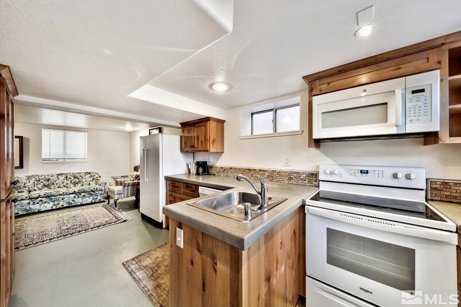 561 Moran Street Reno, NV 89502 - Photo 16 of 40 a kitchen with a stove sink and microwave