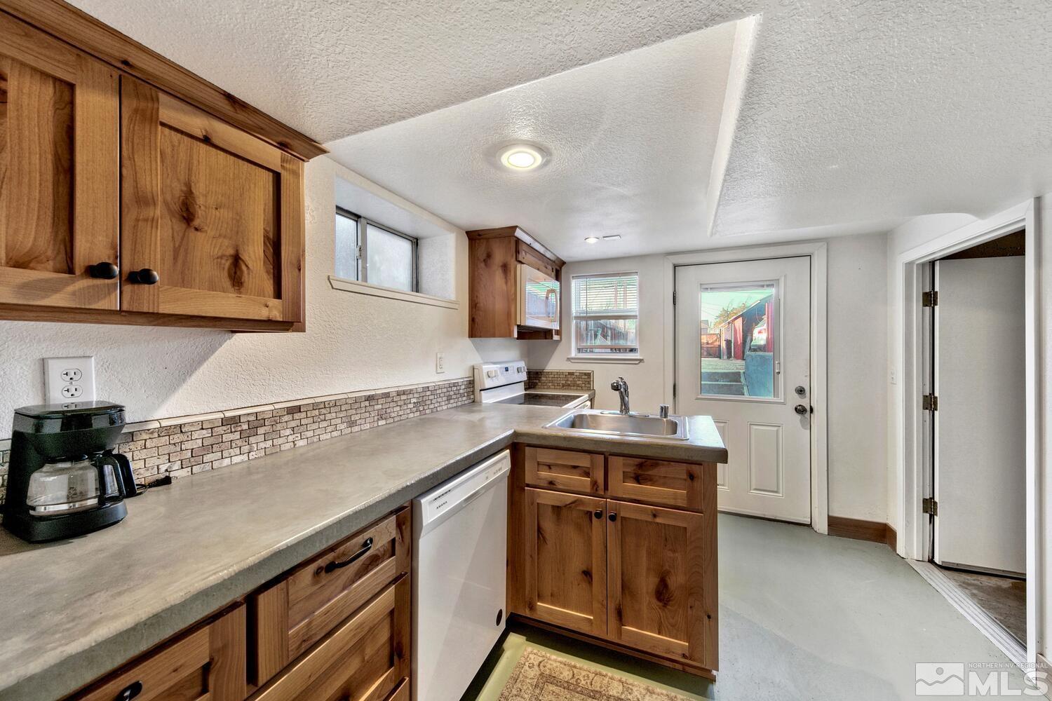 561 Moran Street Reno, NV 89502 - Photo 17 of 40 a kitchen with a sink stove and cabinets