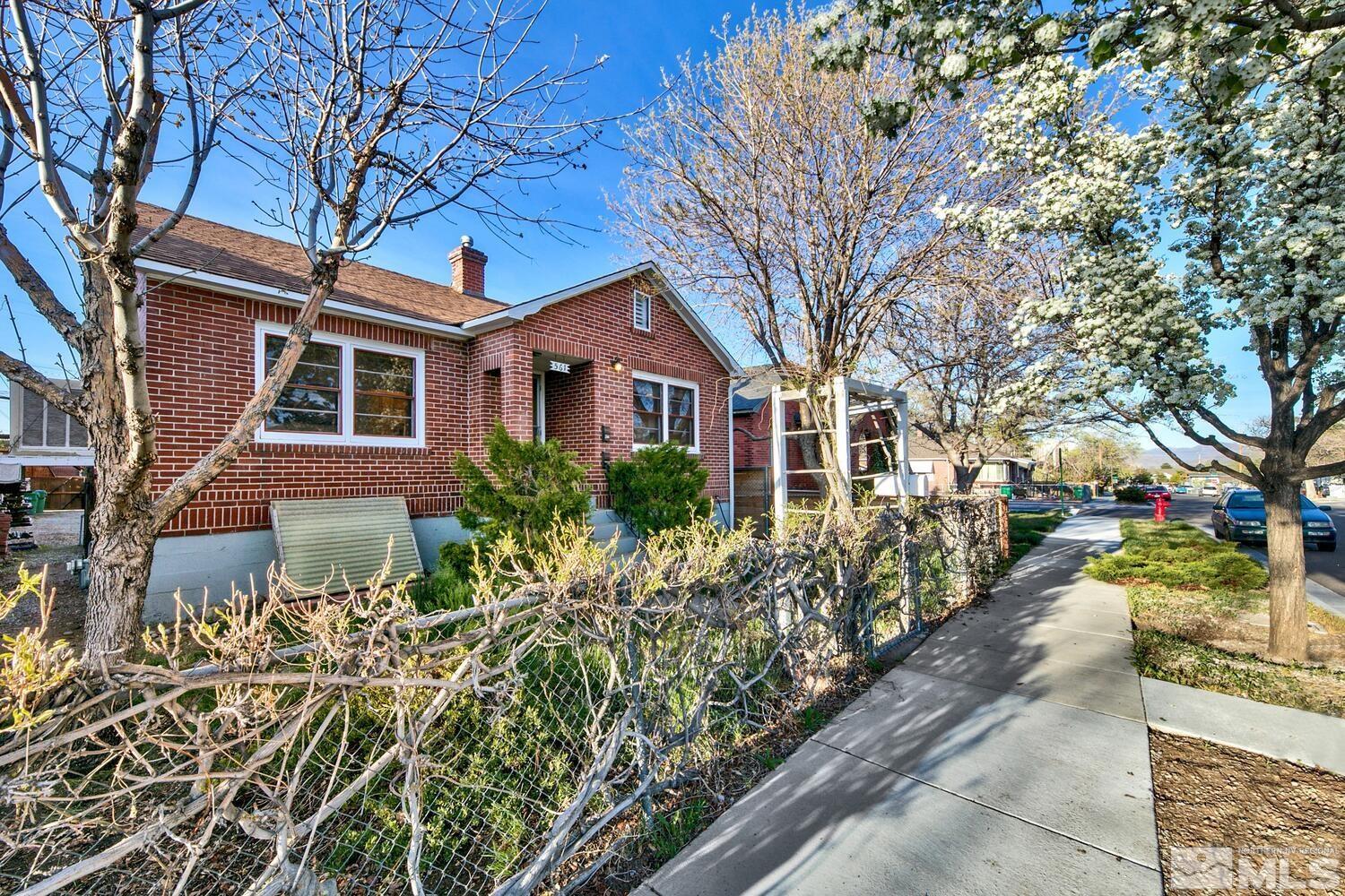 561 Moran Street Reno, NV 89502 - Photo 35 of 40 a front view of a house with a yard and potted plants