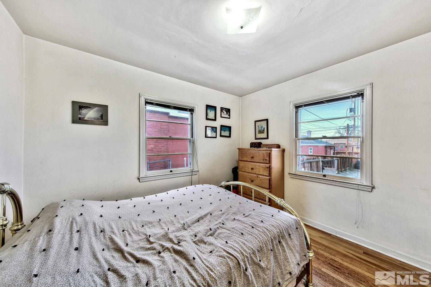561 Moran Street Reno, NV 89502 - Photo 9 of 40 a bedroom with a bed and a dresser next to a window