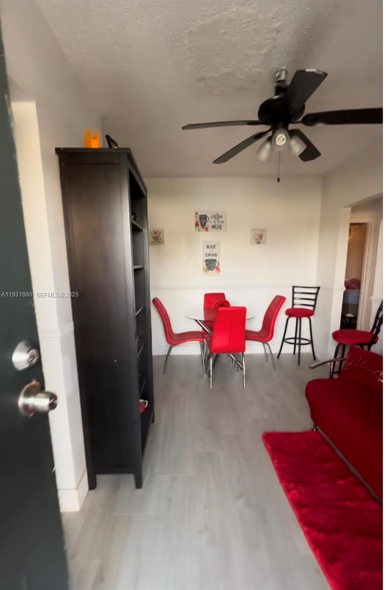 a view of a room with furniture and a fan