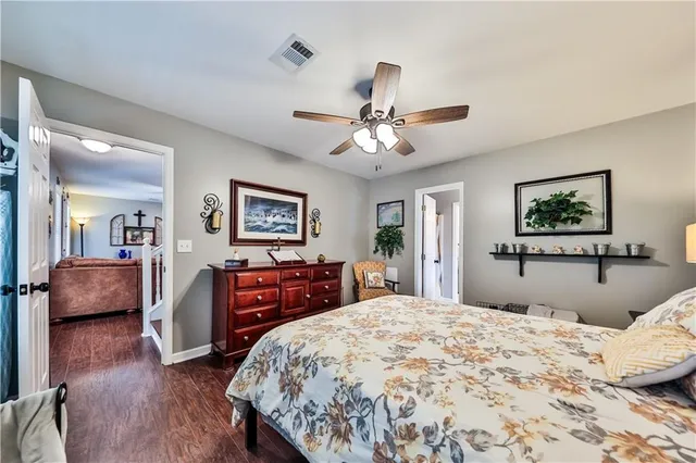 a bedroom with a large bed and a chandelier